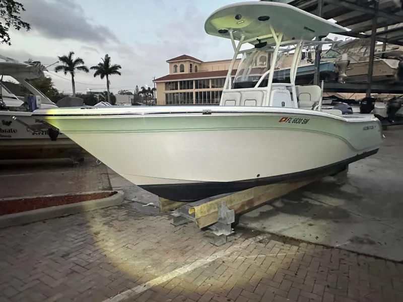 Slide: The Image of 2019 Sea Fox 228 Commander boat on display at a marina with palm trees. - 3