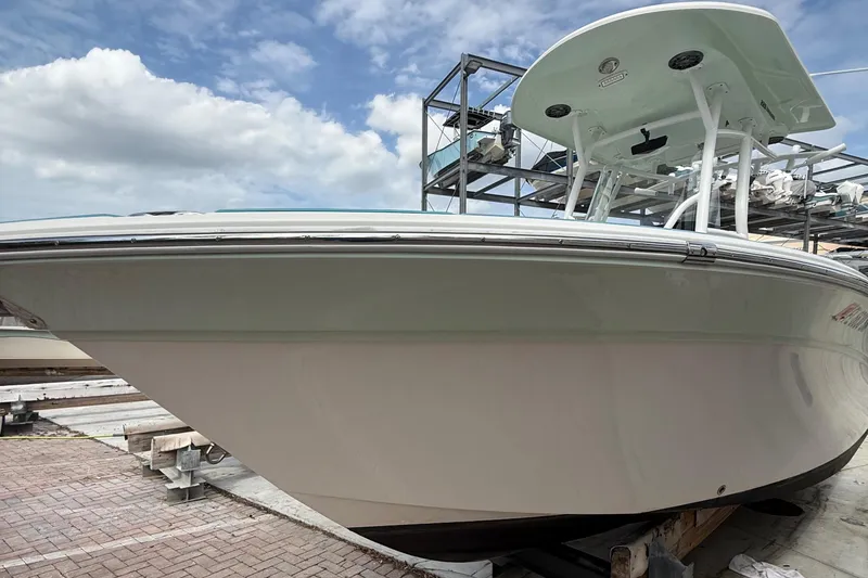 Slide: The Image of 2019 Sea Fox 228 Commander boat on dock under blue sky. - 4