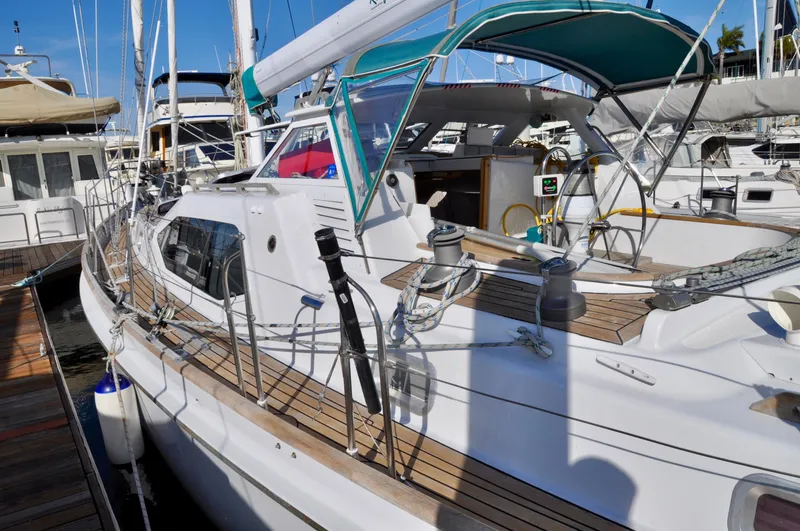 Slide: The Image of Roger Hill 2000 Cruising Cutter yacht docked, featuring sleek design and spacious deck. - 11