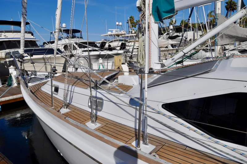 Slide: The Image of Roger Hill 2000 Cruising Cutter docked at marina, surrounded by other boats. - 12