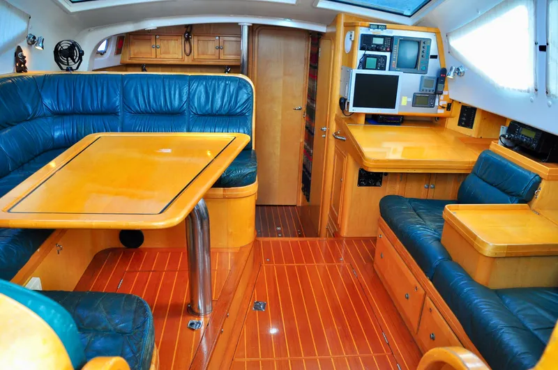 Slide: The Image of Luxurious interior of 2000 Roger Hill Cruising Cutter with wood finish and blue seating. - 17