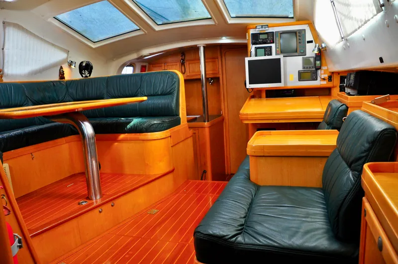 Slide: The Image of Luxurious interior of a 2000 Roger Hill Cruising Cutter with leather seating and wood finish. - 18