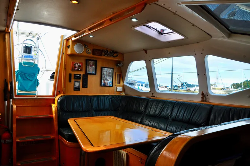 Slide: The Image of Interior of 2000 Roger Hill Cruising Cutter with wooden table and leather seating. - 20