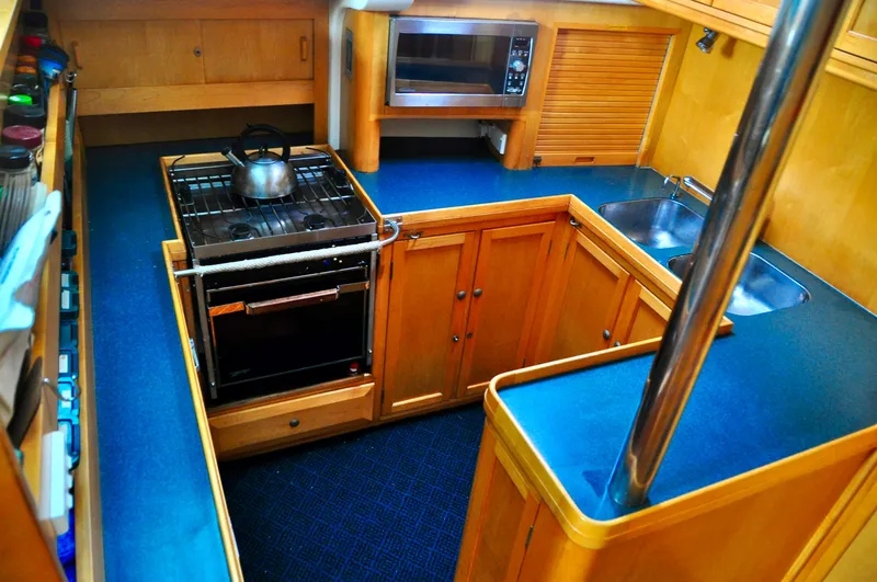 Slide: The Image of Galley kitchen in 2000 Roger Hill Cruising Cutter with stove, sink, and microwave. - 23