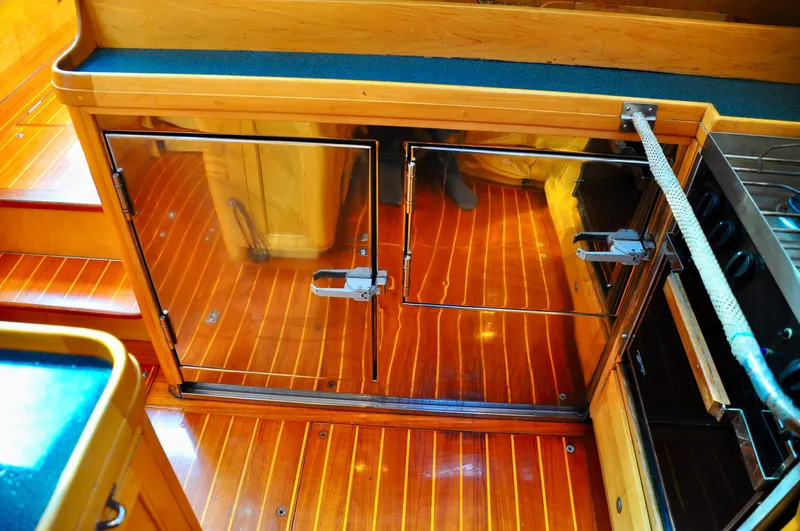 Slide: The Image of Interior of 2000 Roger Hill Cruising Cutter with polished wood flooring and cabinetry. - 26