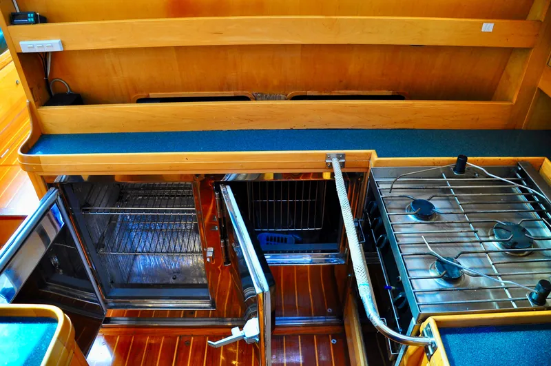 Slide: The Image of Galley kitchen in 2000 Roger Hill Cruising Cutter with stove, oven, and fridge. - 27