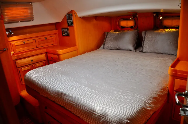 Slide: The Image of Cozy cabin interior of 2000 Roger Hill Cruising Cutter with wooden furnishings and comfortable bedding. - 29