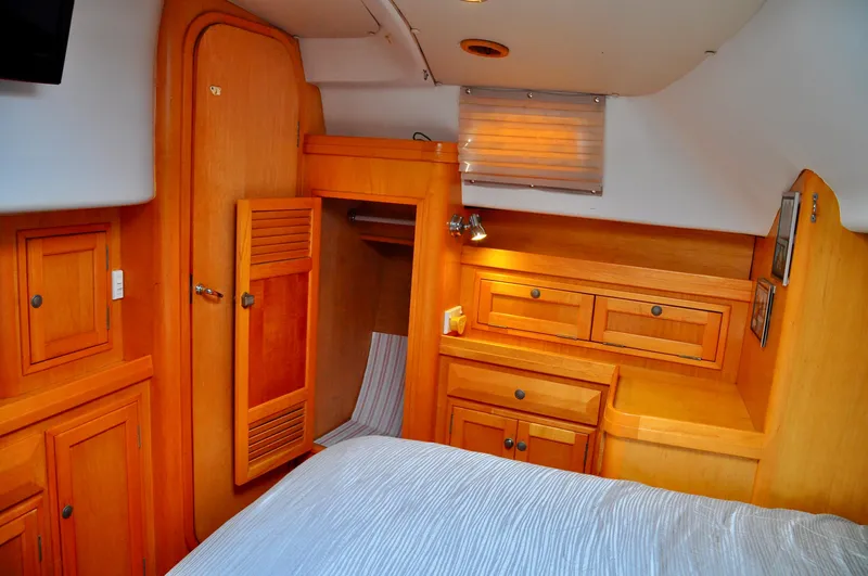 Slide: The Image of Interior of 2000 Roger Hill Cruising Cutter with wooden cabinetry and cozy sleeping area. - 31