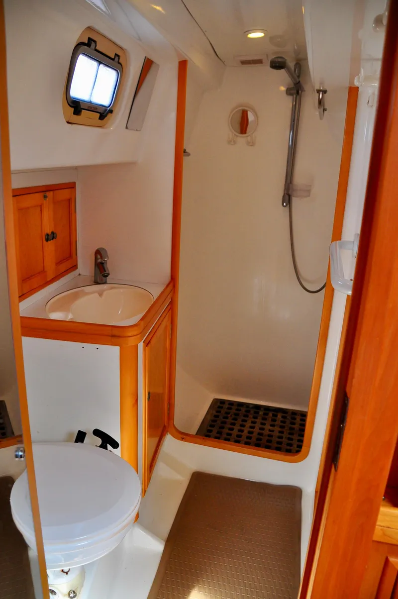 Slide: The Image of Bathroom interior of 2000 Roger Hill Cruising Cutter with shower and wooden cabinetry. - 33