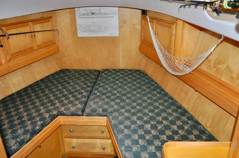 Slide: The Image of Interior of 2000 Roger Hill Cruising Cutter with cozy cabin and checkered bedding. - 35