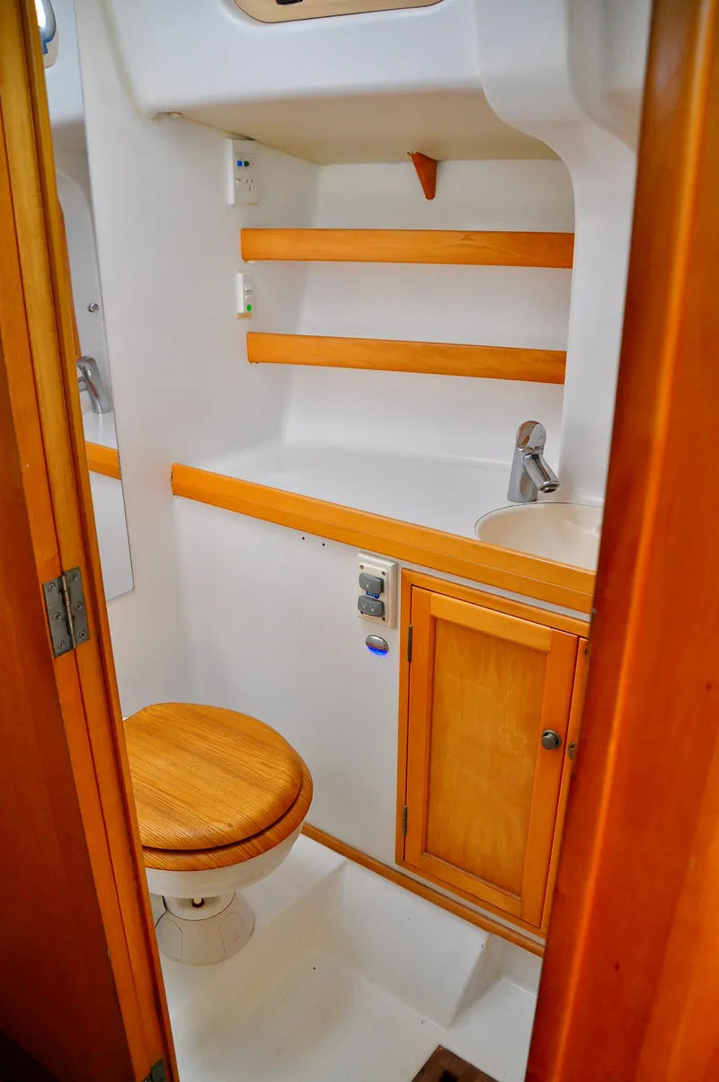 Slide: The Image of Compact bathroom in 2000 Roger Hill Cruising Cutter, featuring wooden accents and modern fixtures. - 36