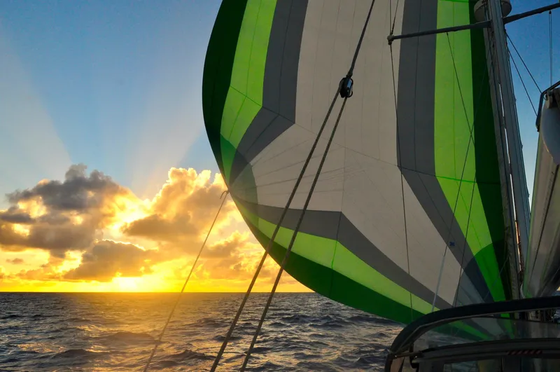 Slide: The Image of Sailing at sunset on a 2000 Roger Hill Cruising Cutter with vibrant spinnaker. - 43