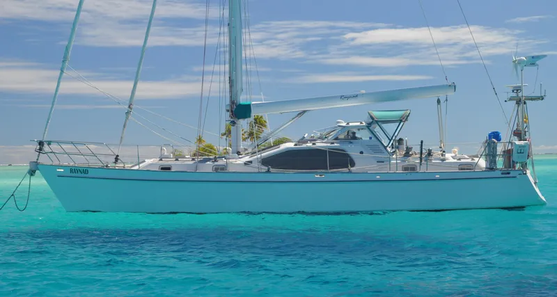 Slide: The Image of Roger Hill 2000 Cruising Cutter sailing on clear turquoise waters. - 45