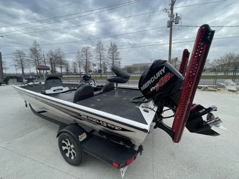 Slide: The Image of 2015 Ranger RT188 boat with Mercury Pro XS engine, parked outdoors under cloudy sky. - 3