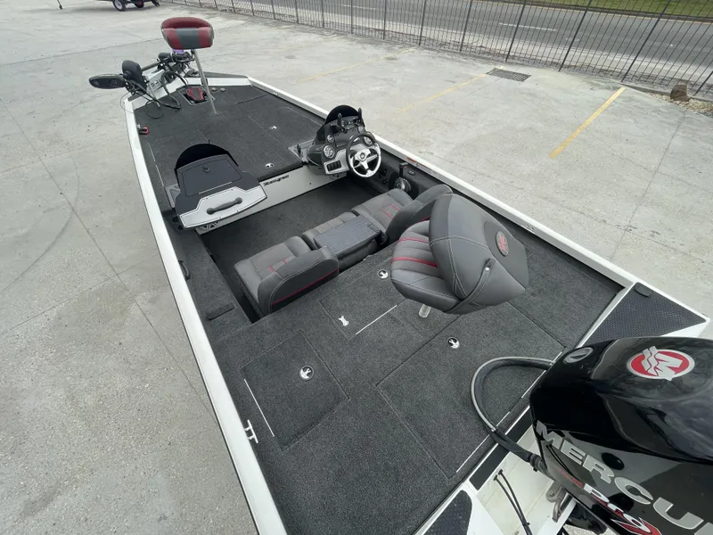 Slide: The Image of 2015 Ranger RT188 boat interior with seating and steering wheel, parked on concrete. - 5