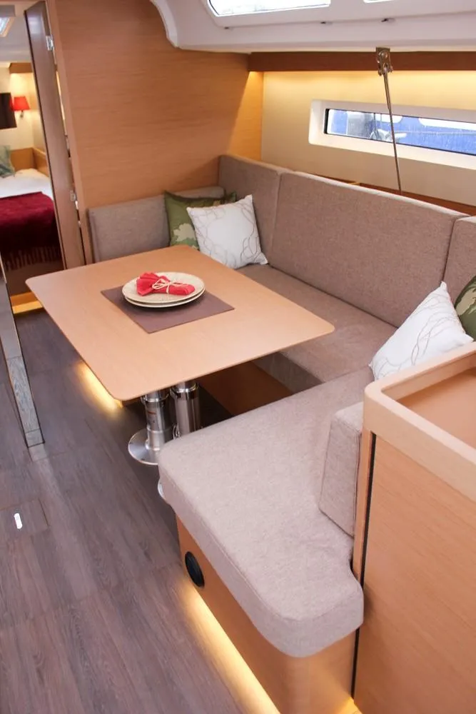 Slide: The Image of Interior of 2025 Jeanneau Sun Odyssey 440 yacht with cozy seating and dining area. - 40