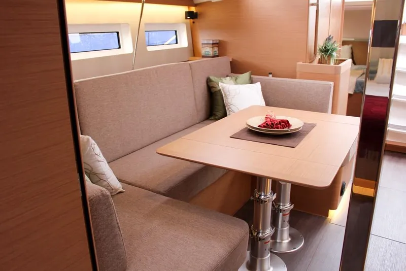 Slide: The Image of Interior of 2025 Jeanneau Sun Odyssey 440 yacht with cozy seating and dining area. - 41