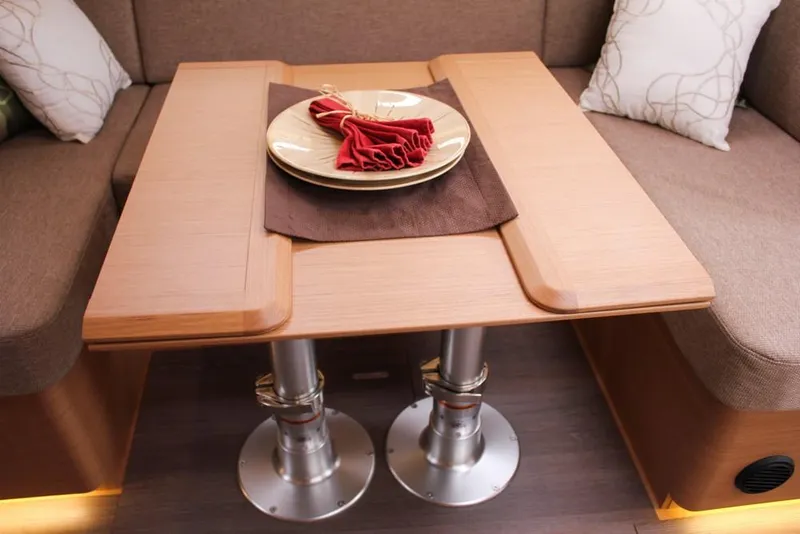 Slide: The Image of Interior of 2025 Jeanneau Sun Odyssey 440 yacht with elegant wooden table setting. - 46