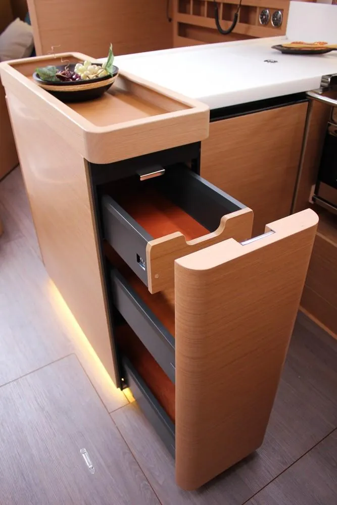 Slide: The Image of Modern kitchen drawer in 2025 Jeanneau Sun Odyssey 440 yacht, featuring sleek wood design. - 19