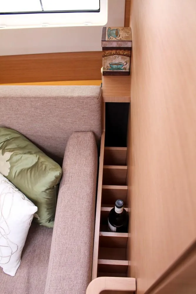 Slide: The Image of Interior of 2025 Jeanneau Sun Odyssey 440 with sofa and built-in bottle storage. - 37