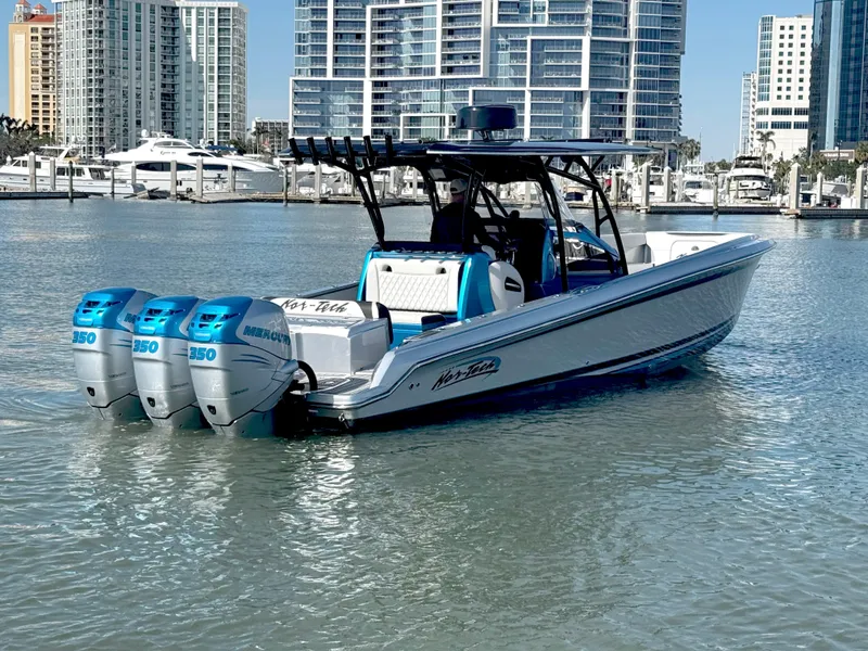 Slide: The Image of 2020 Nor-Tech 340 Sport Open Center Console boat with triple Mercury engines in a marina. - 1