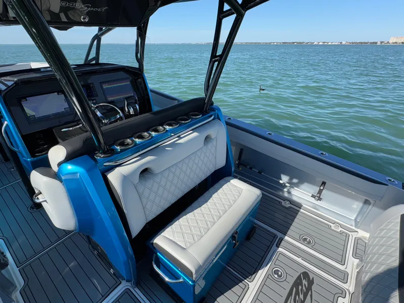 Slide: The Image of 2020 Nor-Tech 340 Sport Open Center Console boat interior on water. - 11