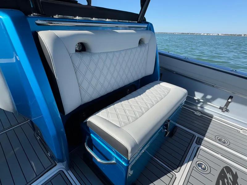 Slide: The Image of 2020 Nor-Tech 340 Sport Open Center Console with blue and white seating, on the water. - 12