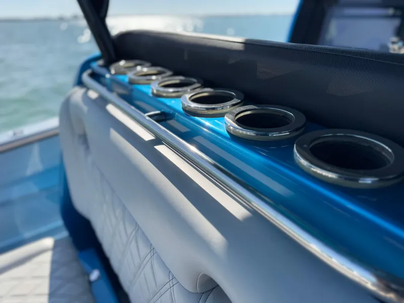 Slide: The Image of 2020 Nor-Tech 340 Sport Open Center Console boat interior with cup holders. - 13