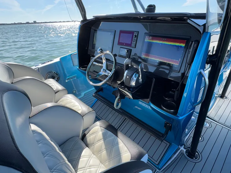 Slide: The Image of 2020 Nor-Tech 340 Sport Open Center Console, modern helm with dual displays on water. - 14