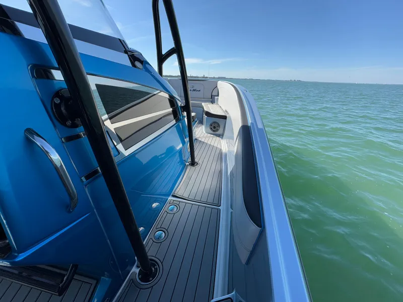 Slide: The Image of 2020 Nor-Tech 340 Sport Open Center Console on calm sea, blue exterior. - 15