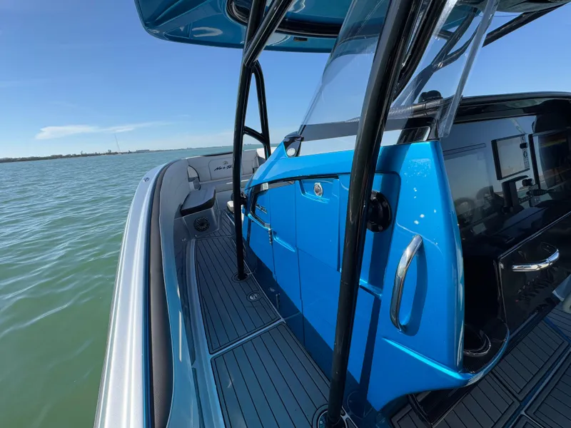 Slide: The Image of 2020 Nor-Tech 340 Sport Open Center Console on calm water, showcasing sleek design. - 16