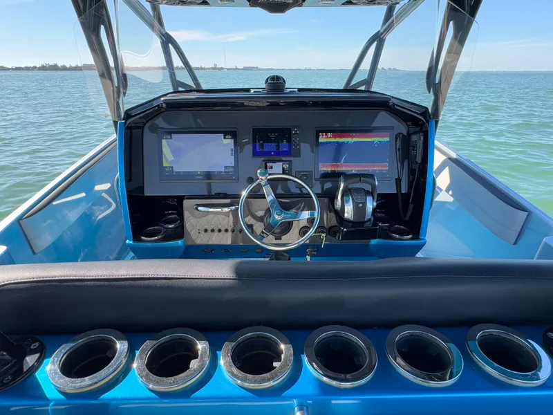 Slide: The Image of 2020 Nor-Tech 340 Sport Open Center Console dashboard with navigation screens and steering wheel. - 17