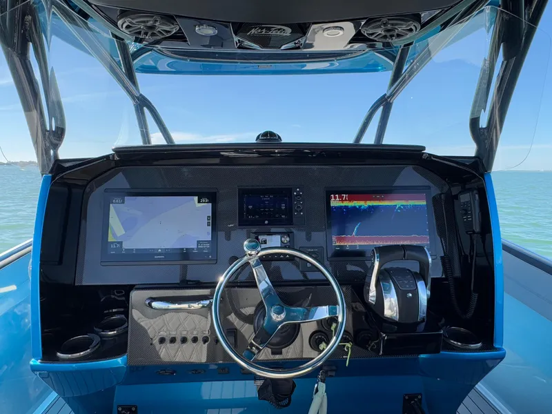 Slide: The Image of 2020 Nor-Tech 340 Sport Open Center Console dashboard with advanced navigation displays. - 18