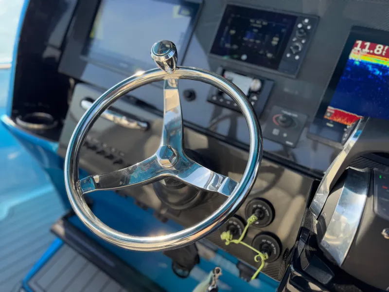 Slide: The Image of Steering wheel of 2020 Nor-Tech 340 Sport Open Center Console boat. - 25