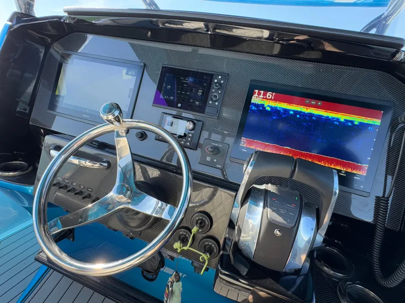 Slide: The Image of 2020 Nor-Tech 340 Sport Open Center Console dashboard with advanced navigation displays. - 26