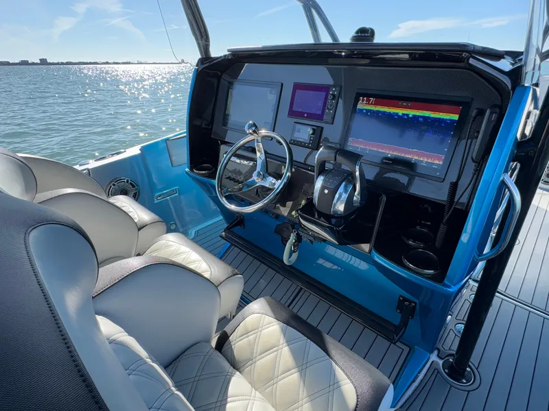 Slide: The Image of 2020 Nor-Tech 340 Sport Open Center Console helm with modern navigation displays on the water. - 27