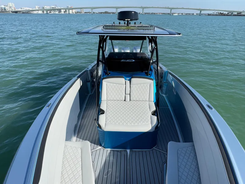 Slide: The Image of 2020 Nor-Tech 340 Sport Open Center Console boat on calm water, featuring sleek seating and modern design. - 28