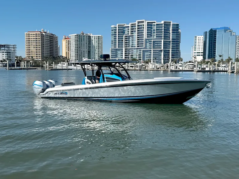 Slide: The Image of 2020 Nor-Tech 340 Sport Open Center Console boat on water, city skyline background. - 3