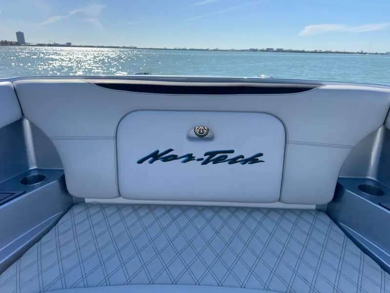 Slide: The Image of 2020 Nor-Tech 340 Sport Open Center Console boat interior with logo, on a sunny day. - 5