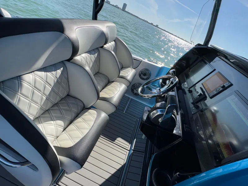 Slide: The Image of 2020 Nor-Tech 340 Sport Open Center Console interior with luxurious seating and modern dashboard. - 8