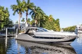 Slide: The Image of 2021 Azimut Verve 47 yacht cruising on a scenic waterway with palm trees. - 3