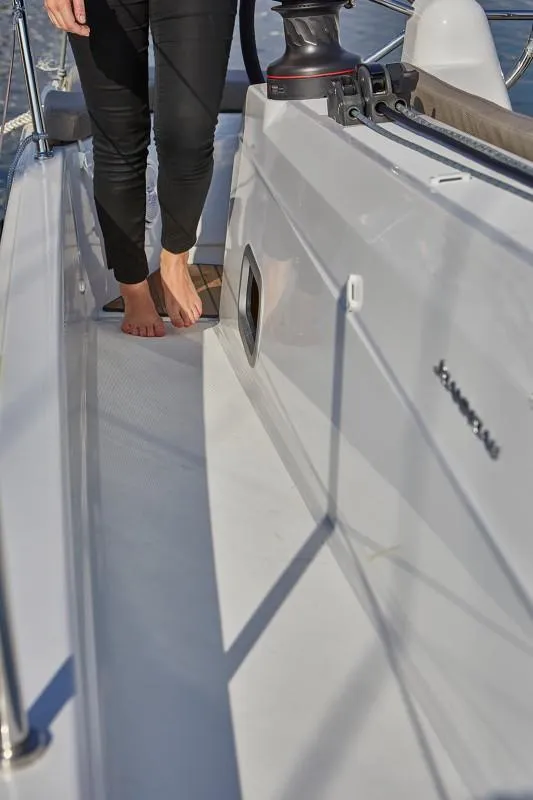 Slide: The Image of 2025 Jeanneau Sun Odyssey 410 deck with person walking barefoot. - 15