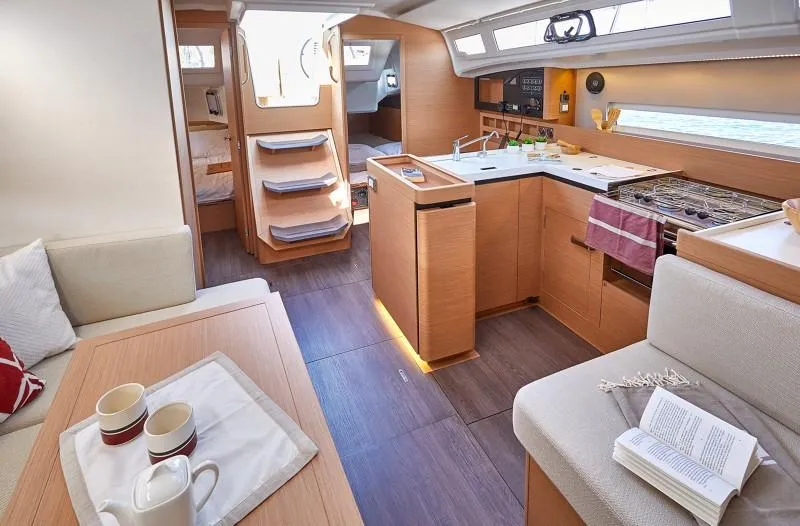 Slide: The Image of Interior of 2025 Jeanneau Sun Odyssey 410 yacht, featuring modern kitchen and cozy seating area. - 8