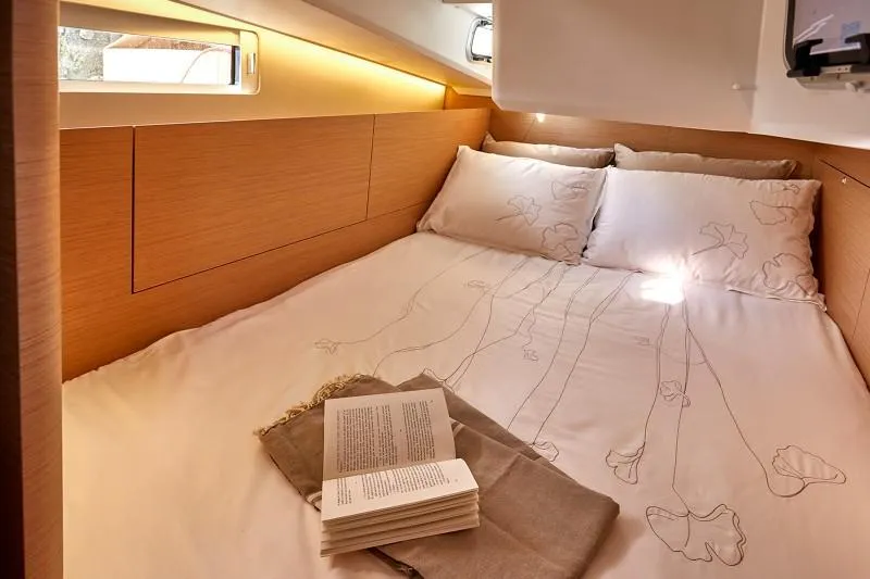 Slide: The Image of Cozy cabin interior of 2025 Jeanneau Sun Odyssey 410 yacht with elegant bedding. - 7