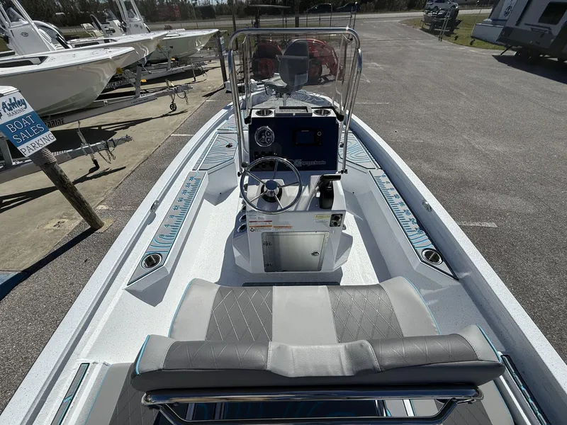 Slide: The Image of 2025 Xpress Hyper-Lift Series H20B boat with new console, parked at a marina. - 7