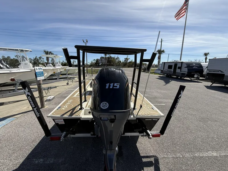 Slide: The Image of 2025 Xpress Skiff 185 boat with 115 horsepower engine in a parking lot. - 11