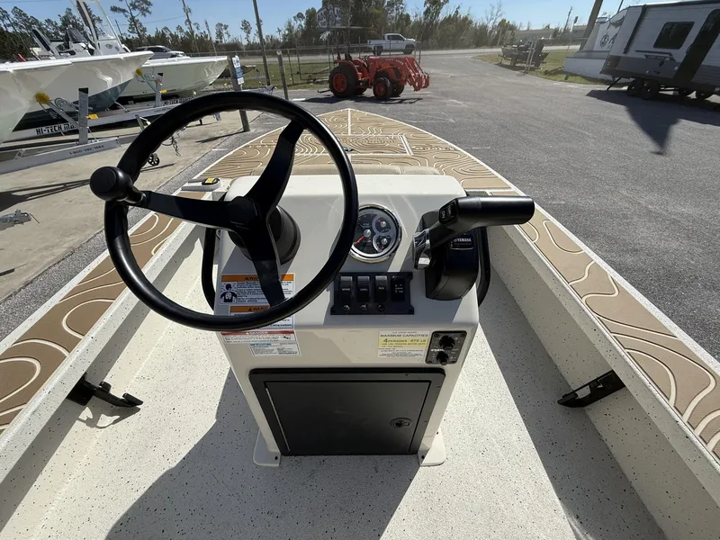 Slide: The Image of 2025 Xpress Skiff 185 boat console with steering wheel and controls. - 3