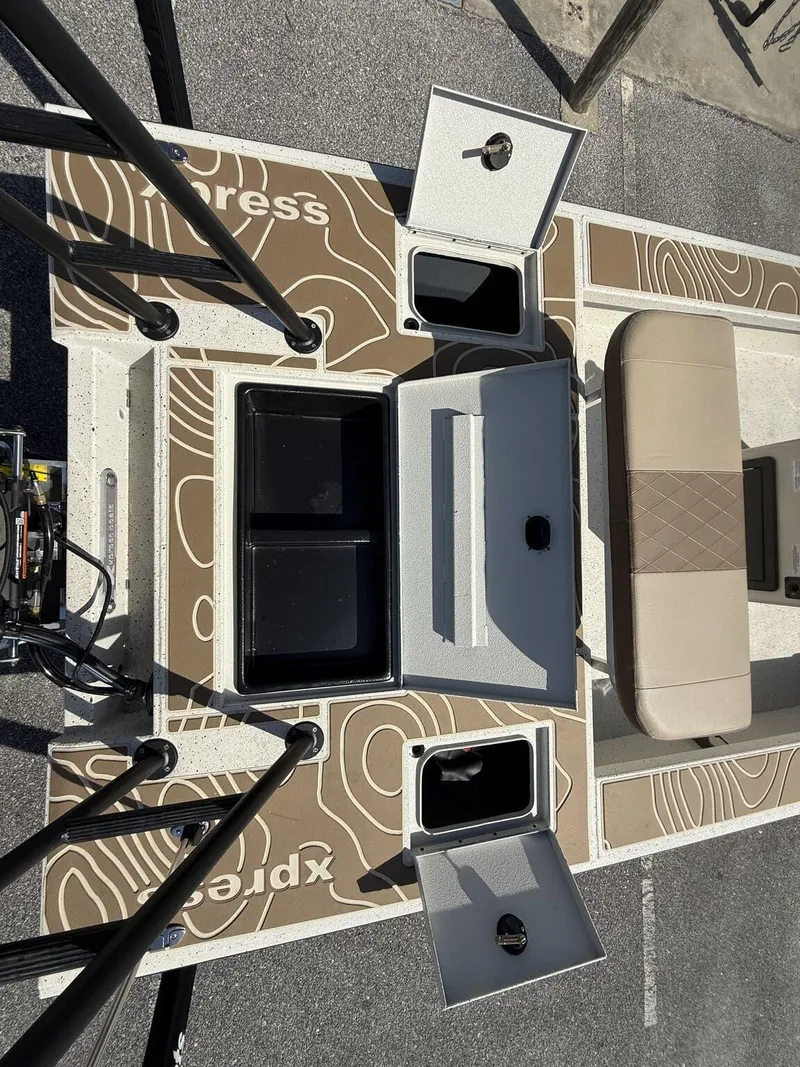 Slide: The Image of 2025 Xpress Skiff 185 boat interior with storage compartments and seating. - 4