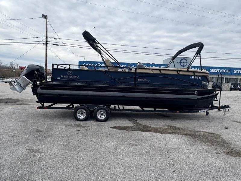Slide: The Image of 2020 Regency 250 DL3 pontoon boat on trailer in parking lot. - 11