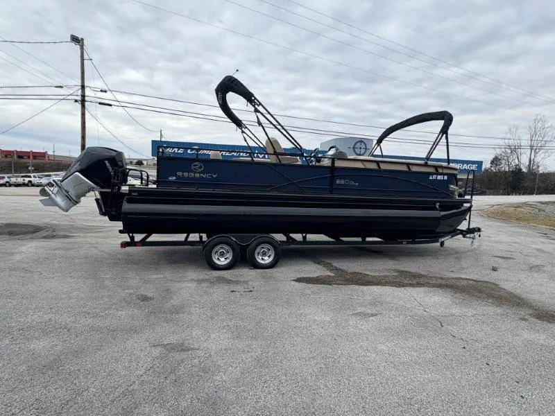 Slide: The Image of 2020 Regency 250 DL3 pontoon boat on trailer, parked outdoors. - 15